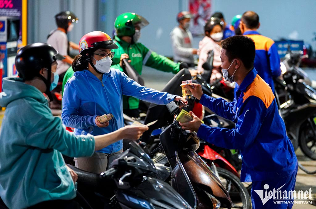 Người dân TP.HCM đội mưa chờ mua xăng trong đêm
