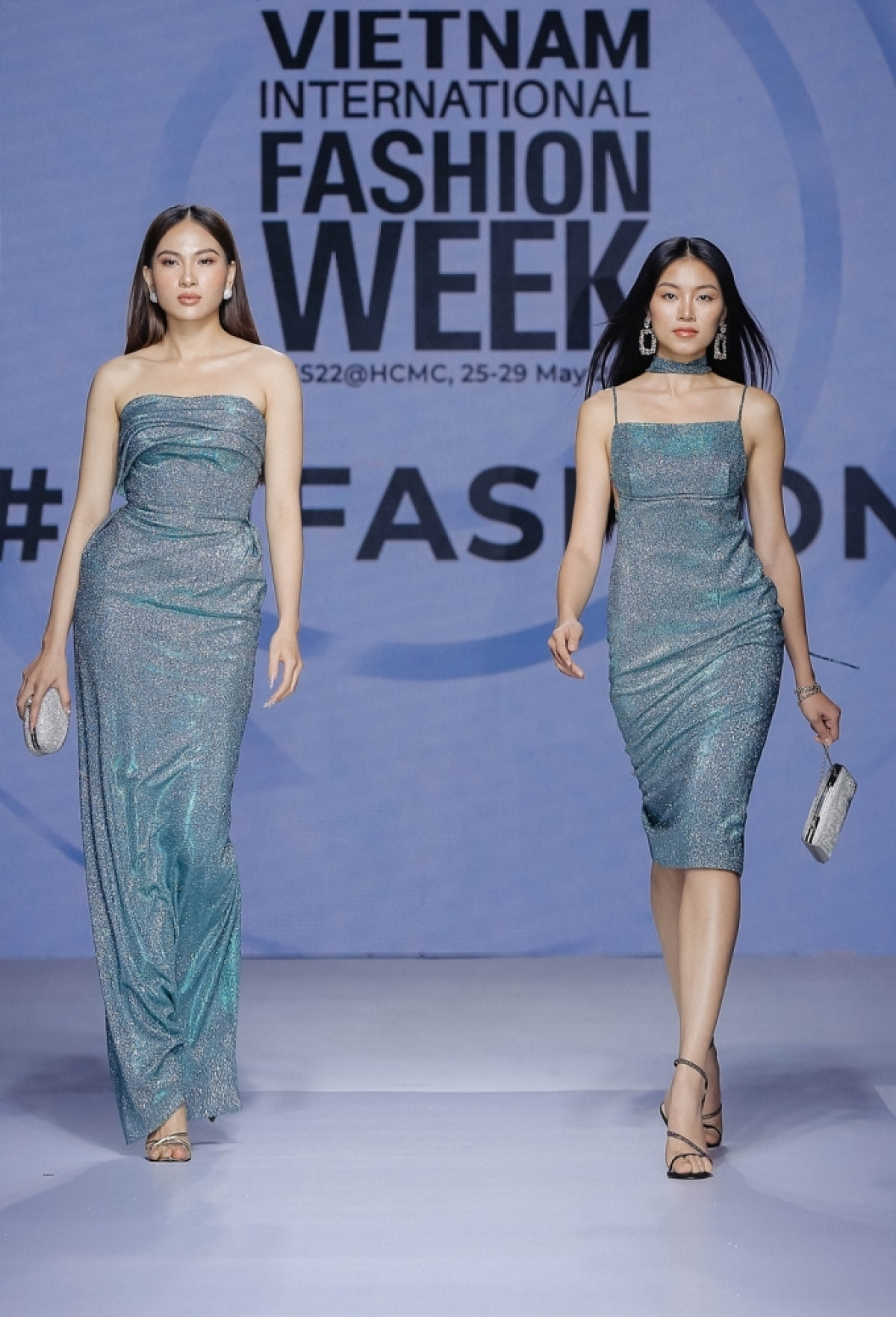 Two outfits by designer Hoang Minh Ha are introduced at the press conference in Ho Chi Minh City on May 9.