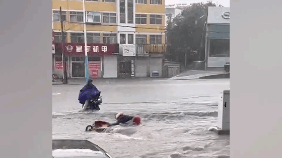 Thanh niên “đội mưa” lao ra đường cứu người phụ nữ đi xe máy bị nước lũ cuốn trôi