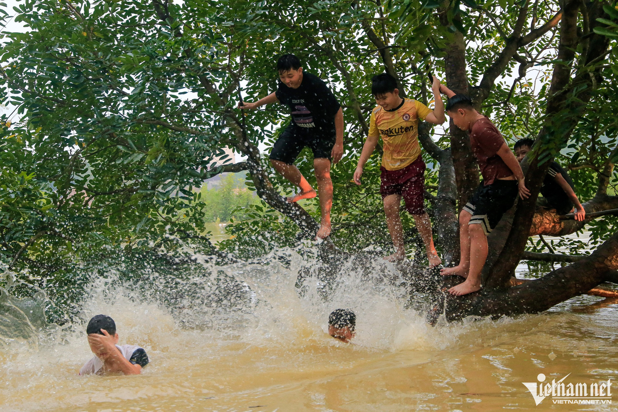 Trẻ em ngoại thành Hà Nội chơi đùa trong làn nước lũ