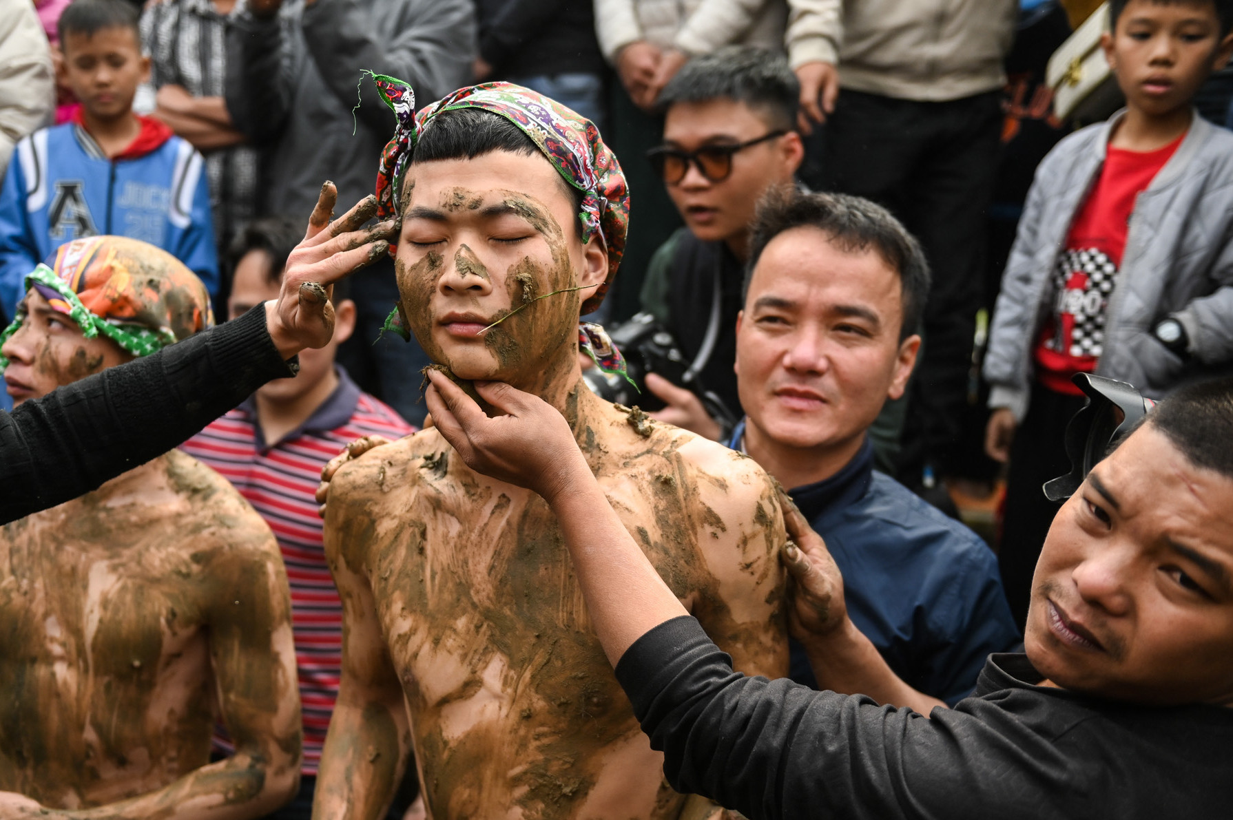 Ba 'ông bụt' cởi trần, bị trát bùn vào người trong lễ hội cầu quý tử