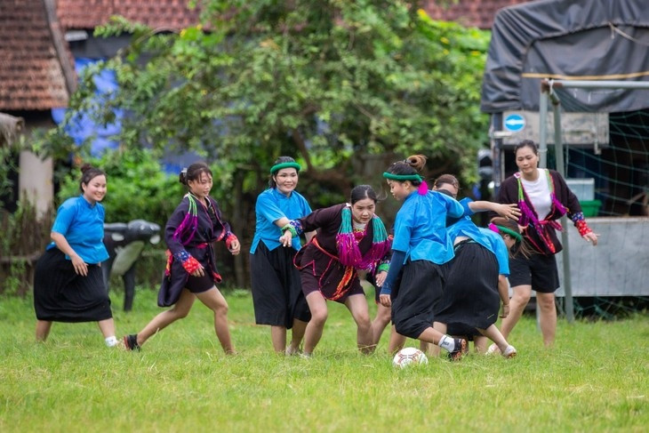 ethnic women in skirts play football in mountainous market picture 1