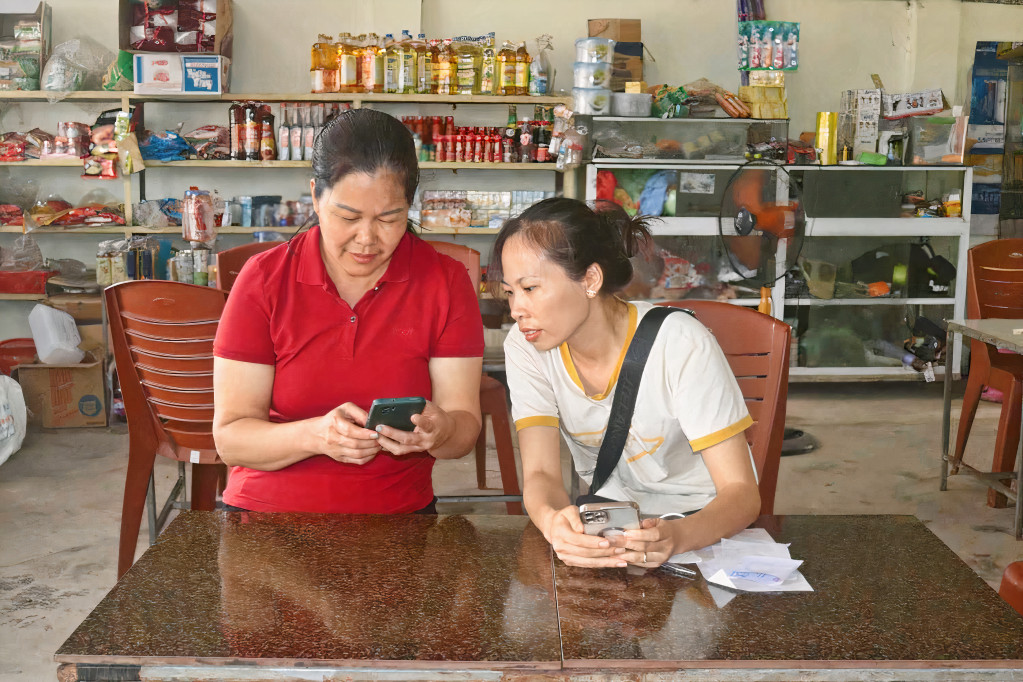 Người dân thôn Đông (xã Dực Yên, huyện Đầm Hà) thực hiện thanh toán chuyển tiền qua ứng dụng ngân hàng từ điện thoại thông minh.