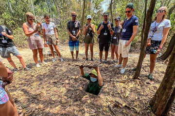 Japanese travelers try food specialty when discovering Cu Chi tunnels