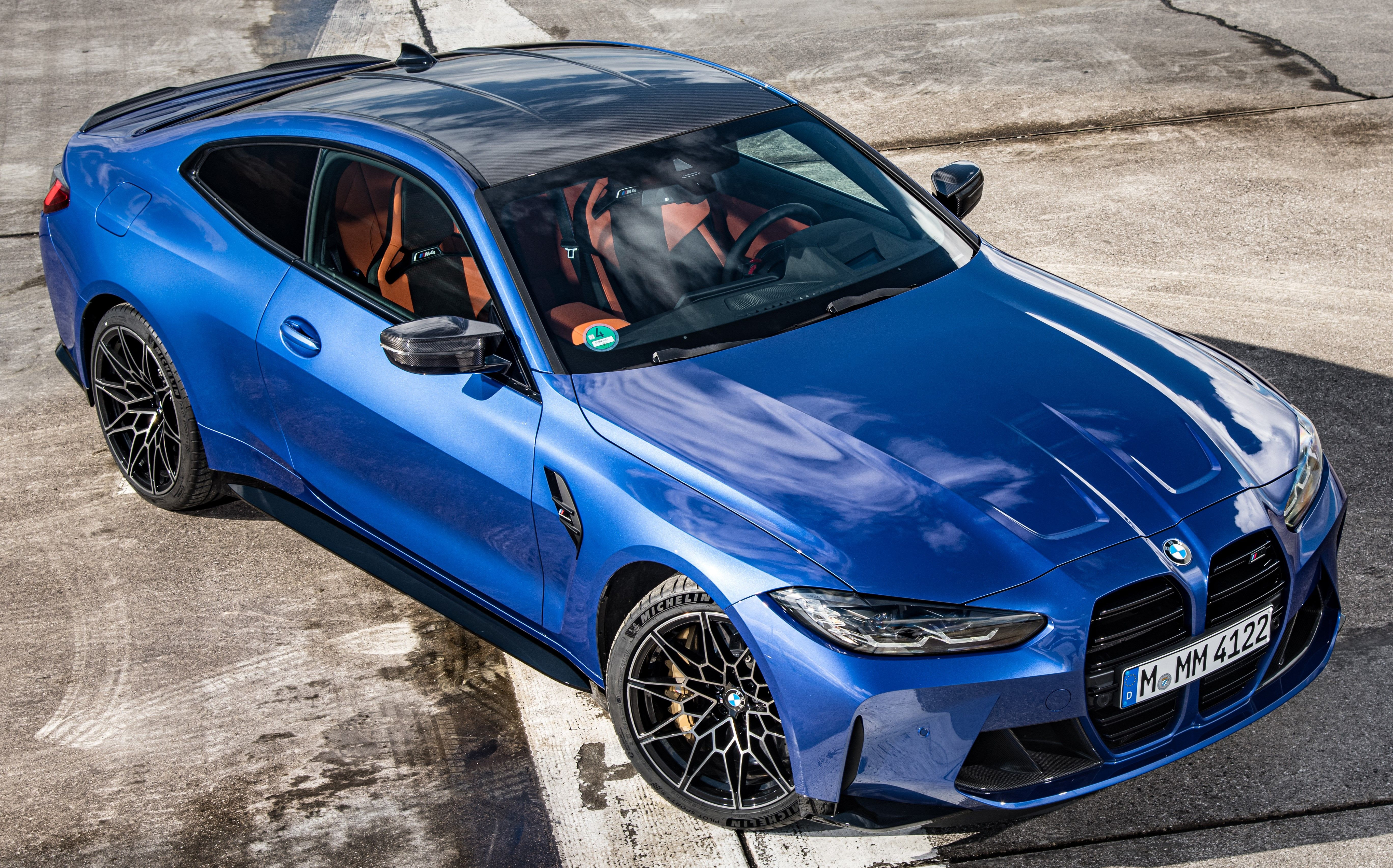 Blue 2023 BMW M4 Competition Coupe parked outdoors