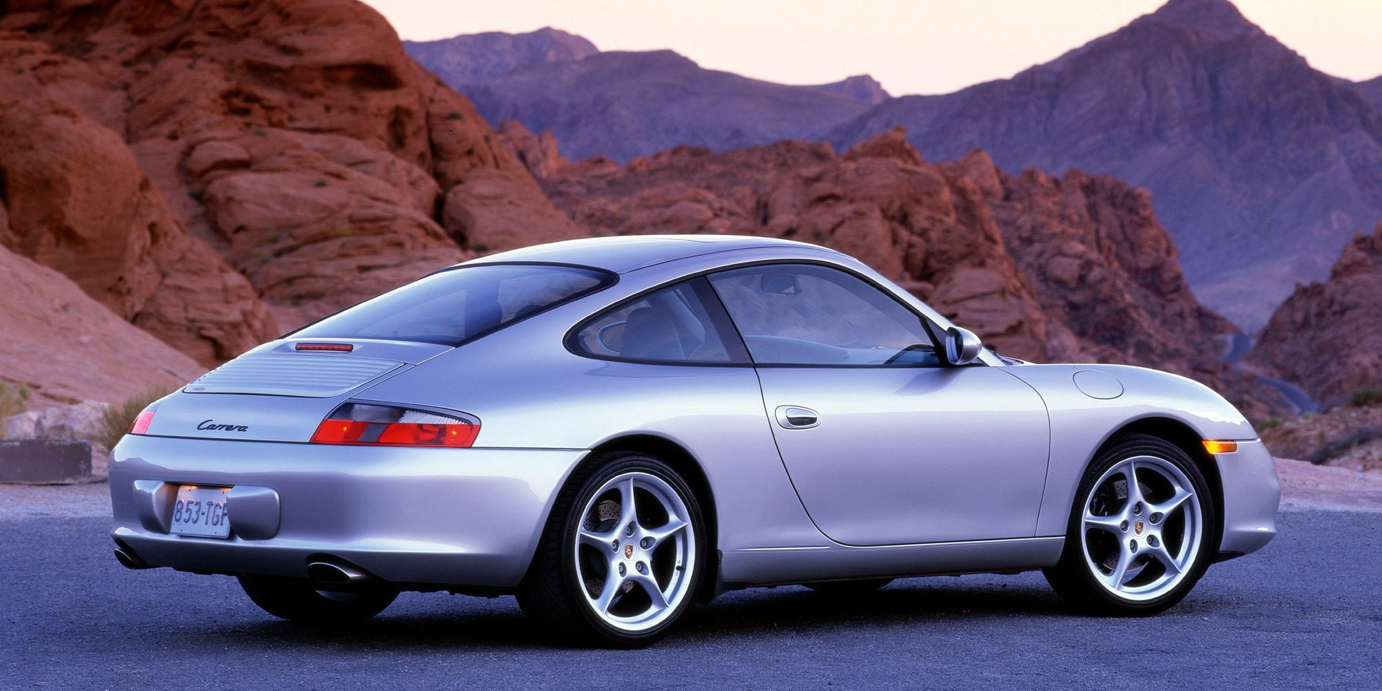 Rear 3/4 view of a silver 996 911 Carrera