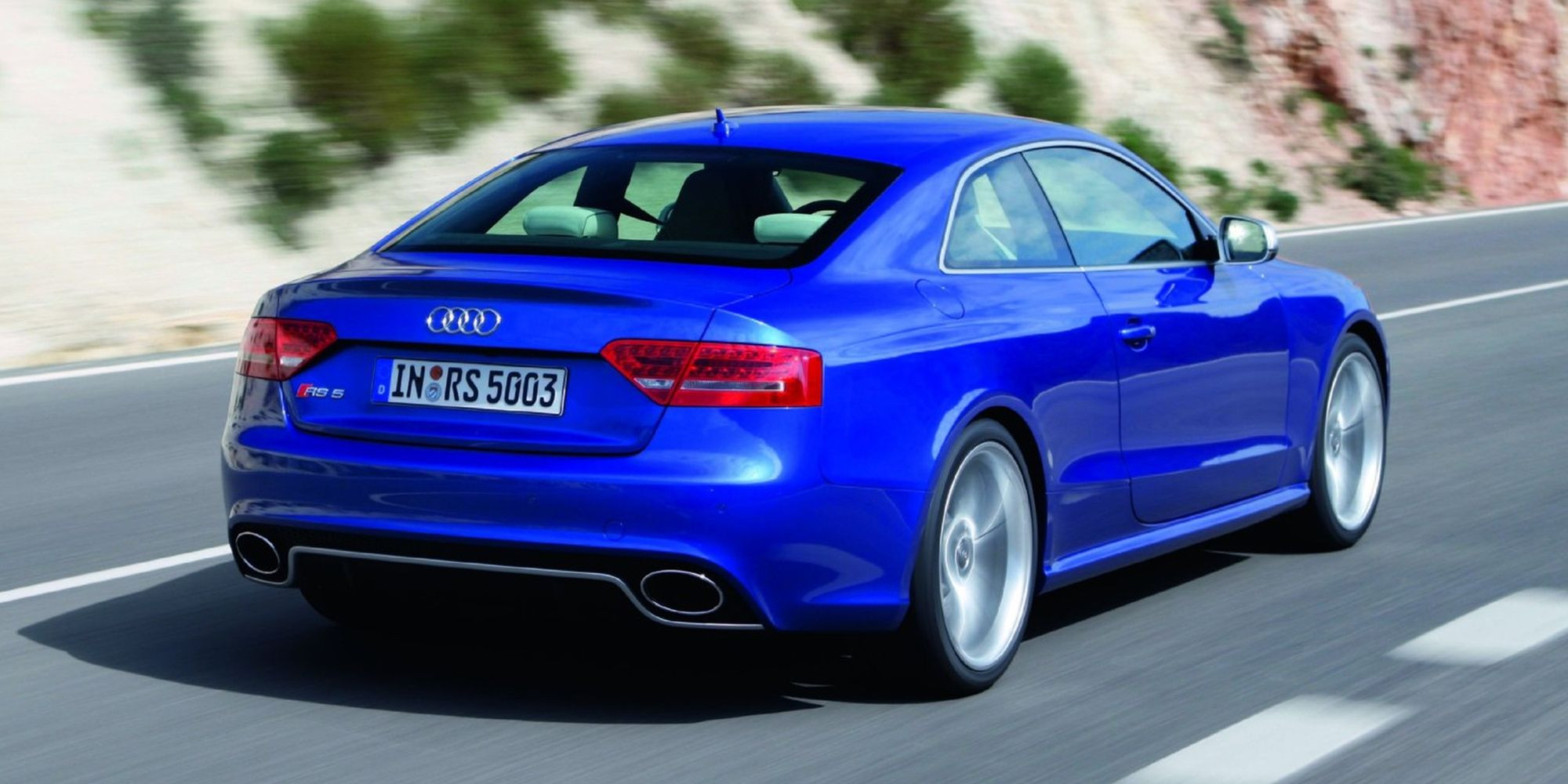 Rear 3/4 view of a blue first gen RS5 on the move