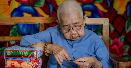 101-year-old woman seamstress sews beautiful royal pillows