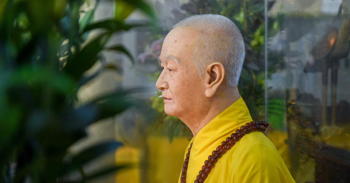 Hyper-realistic venerable monk statue at Hanoi pagoda