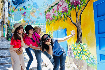 Visitors enjoy murals at Quy Nhon fishing village