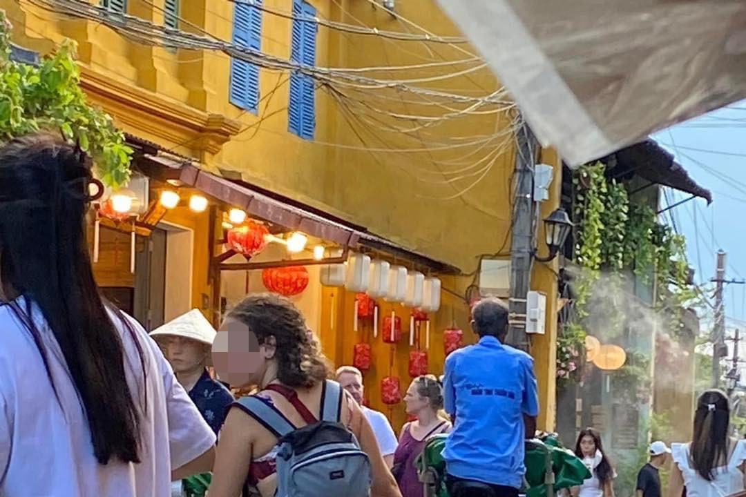 Female tourist in bikini walks around Hoi An, raising eyebrows