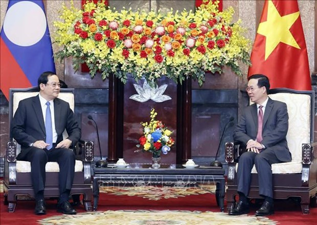 State President hosts Lao Prime Minister in Hanoi hinh anh 1