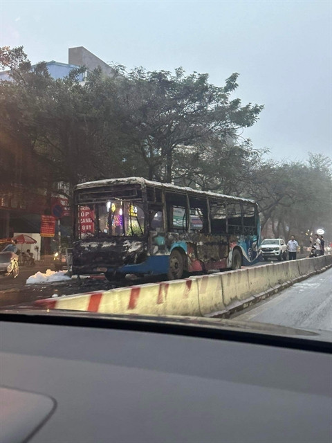 Police extinguish bus fire in Hanoi street early morning