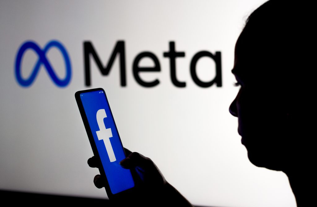 march 16 2022 brazil this photo illustration woman holds smartphone with facebook logo displayed screen with meta platforms logo displayed background 1024x670.jpg