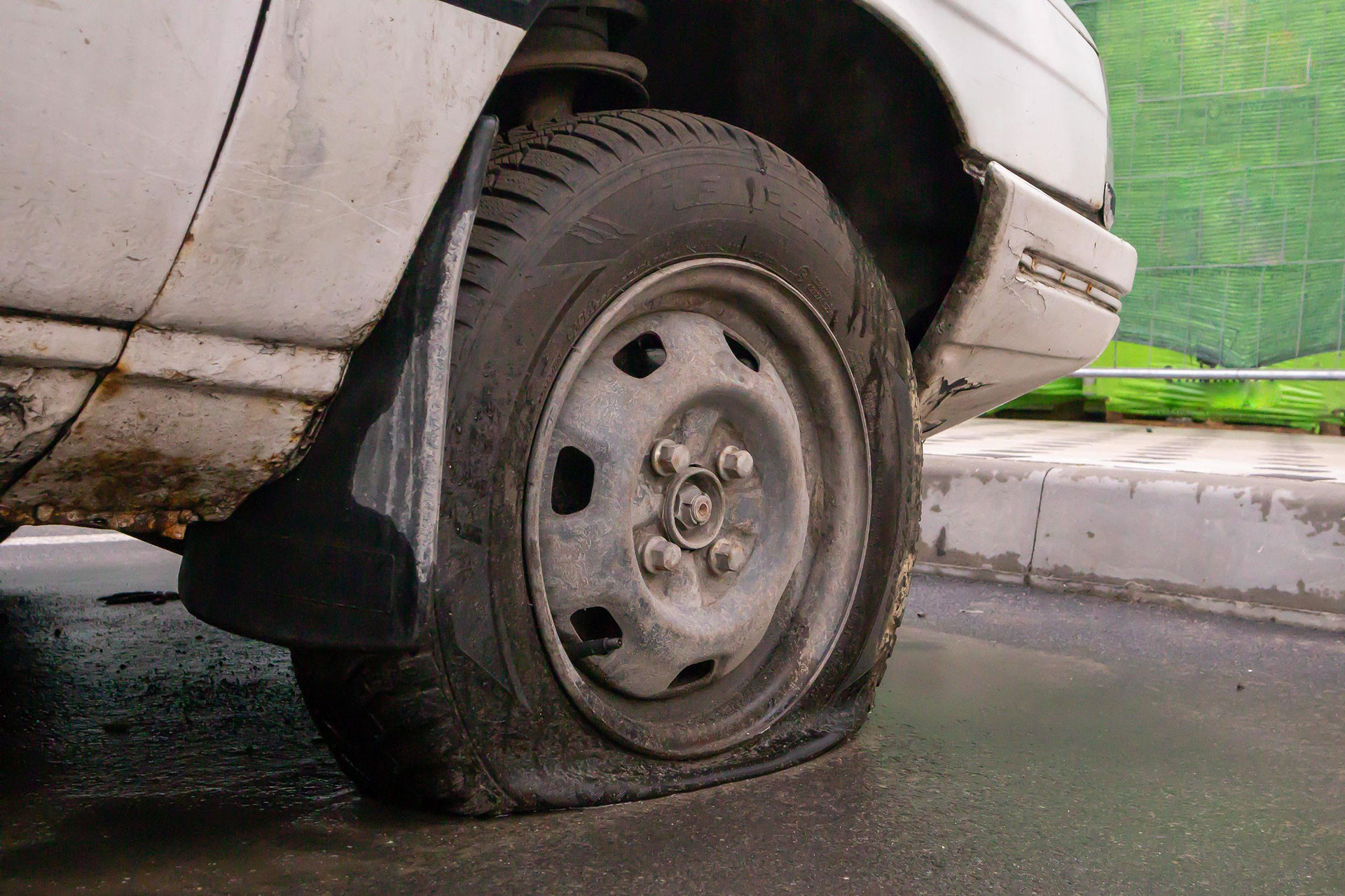 abandoned old broken car with flat wheels a tire with a flat tire the concept of accident breakdown repair insurance a flat tire on a car wheel ukraine kiev august 19 2021 free photo.jpg