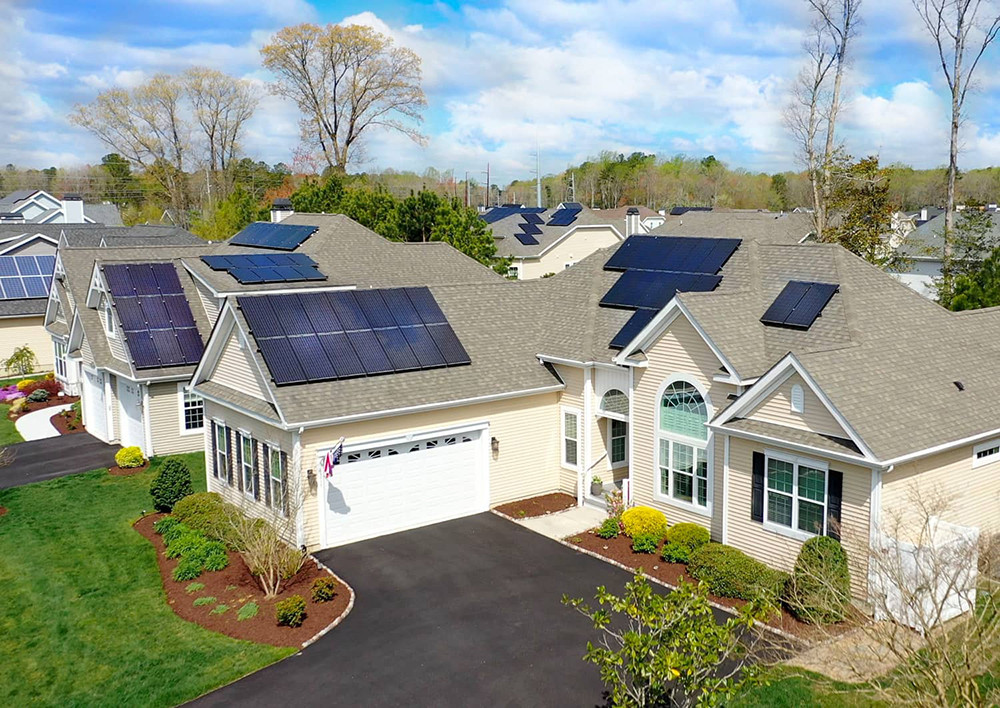 Overhead view of neighborhood and house with solar panels on roof.jpg