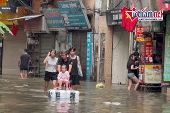 Phố nhỏ ở Hà Nội vẫn ngập như sông, ông làm bè đưa cháu đi dạo