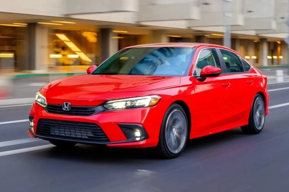 Front angle view of red 2023 Honda Civic highlighting lawsuit for sticky steering wheel that gets stuck .webp