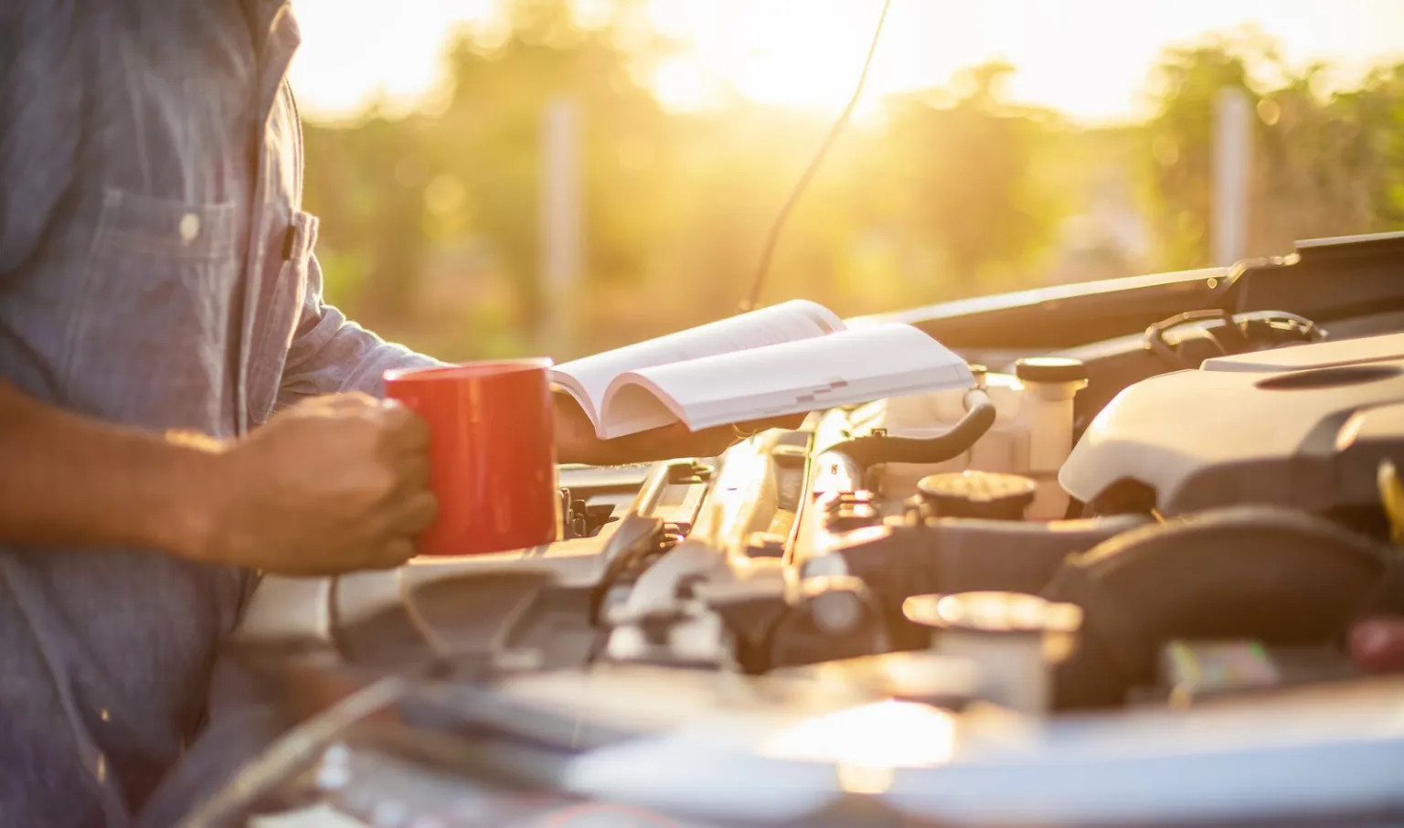 Mechanic reading cars owners manual.webp