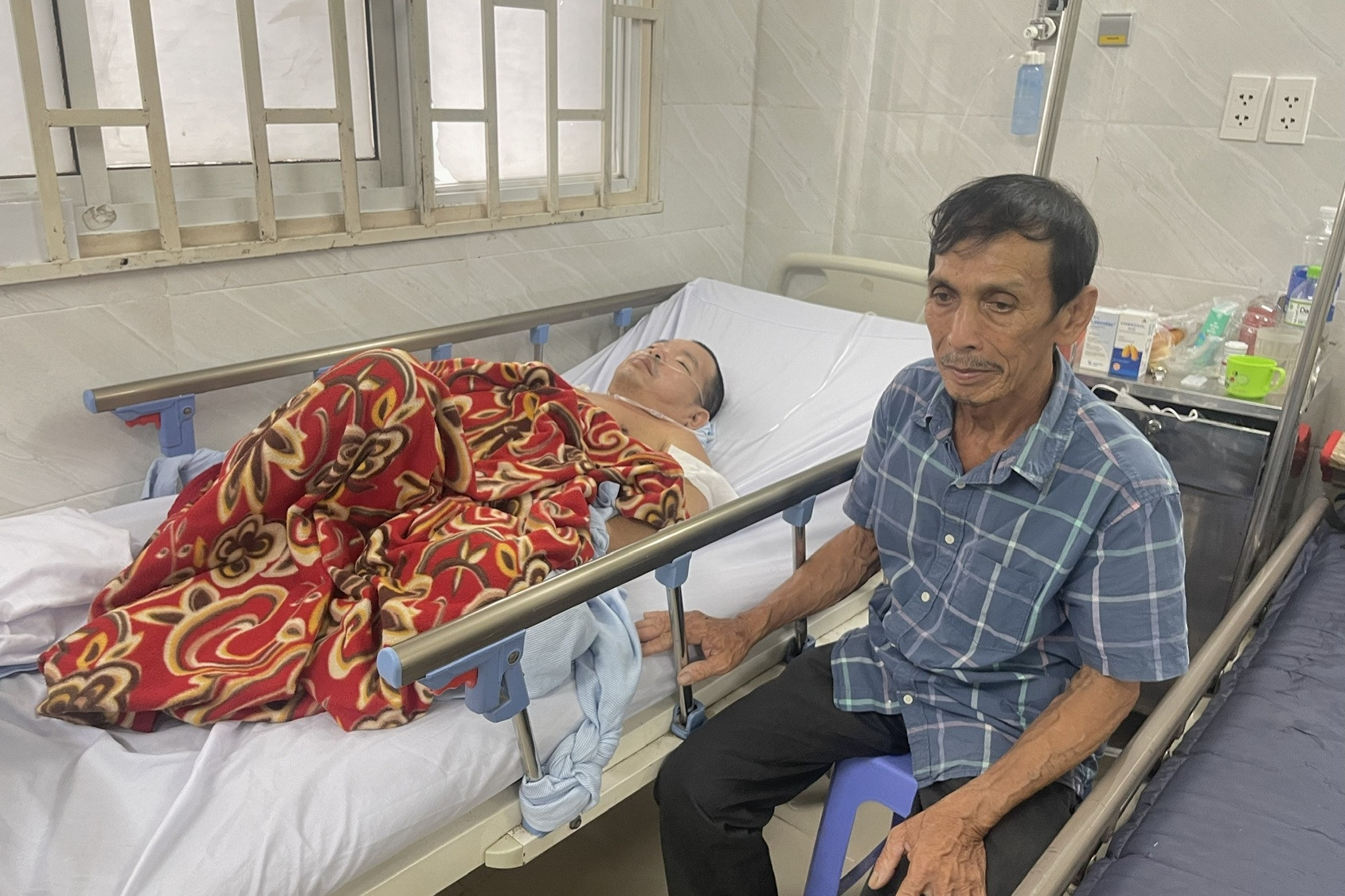 Con trai bại liệt nguy kịch, cha 70 tuổi chạy xe ôm không lo nổi viện phí