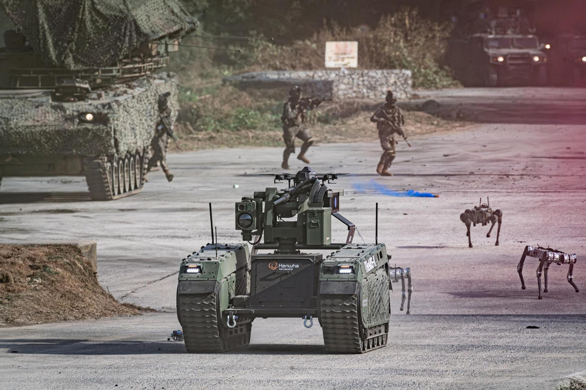 Drones, multipurpose unmanned ground vehicles and quadruped robots advance ahead of soldiers as a smoke-screening drone obscures the simulated enemy's view during an integrated unmanned combat demonstration at the Yangpyeong General Training Ground in Gyeonggi Province, Wednesday. Courtesy of Republic of Korea Army