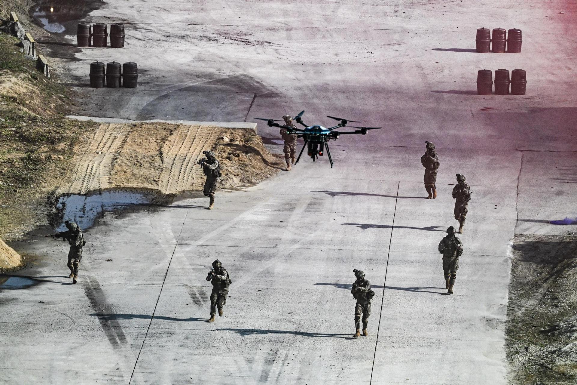 Soldiers advance behind unmanned systems under the cover of a rifle-equipped drone during an integrated unmanned combat demonstration at the Yangpyeong General Training Ground in Gyeonggi Province, Wednesday. Courtesy of Republic of Korea Army