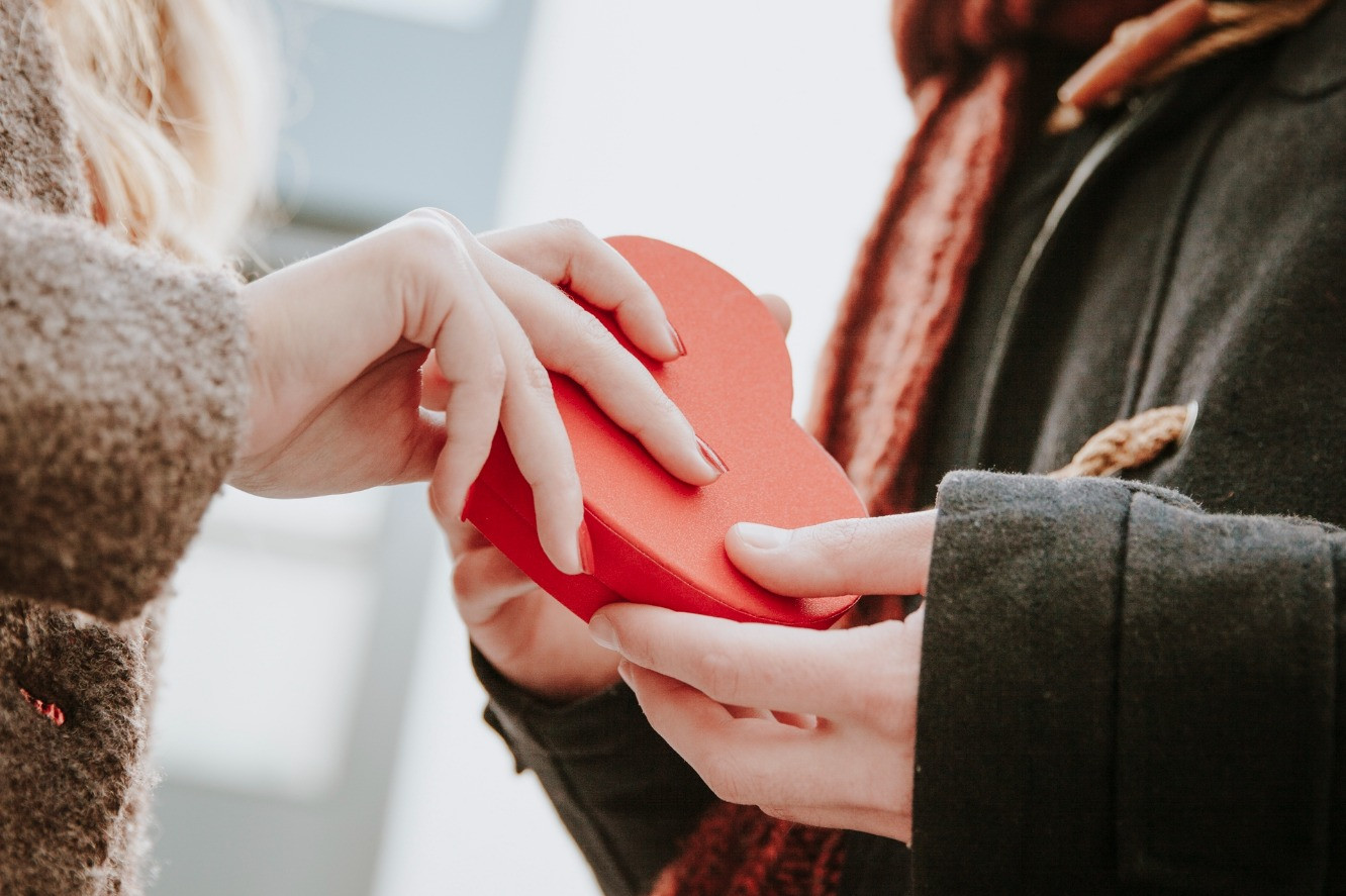 happy woman gifting heart shaped box man (1).jpg