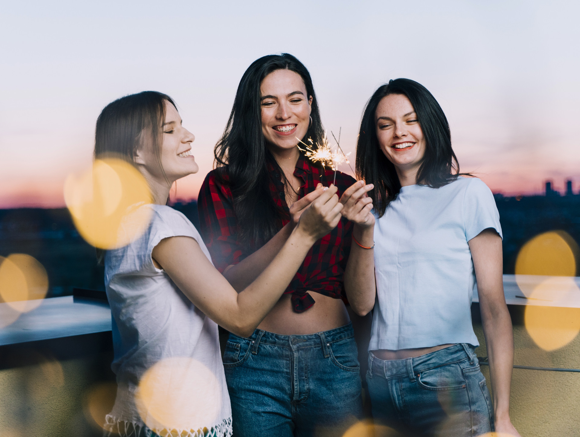 girls holding fireworks rooftop dawn (1).jpg