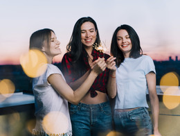 girls holding fireworks rooftop dawn (1).jpg