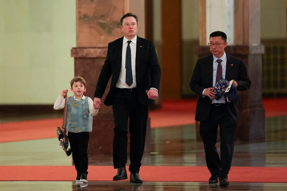 Elon Musk and his son X Æ A-Xii during a visit to China. Photo: Yonhap .