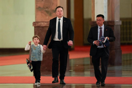 Elon Musk and his son X Æ A-Xii during a visit to China. Photo: Yonhap .