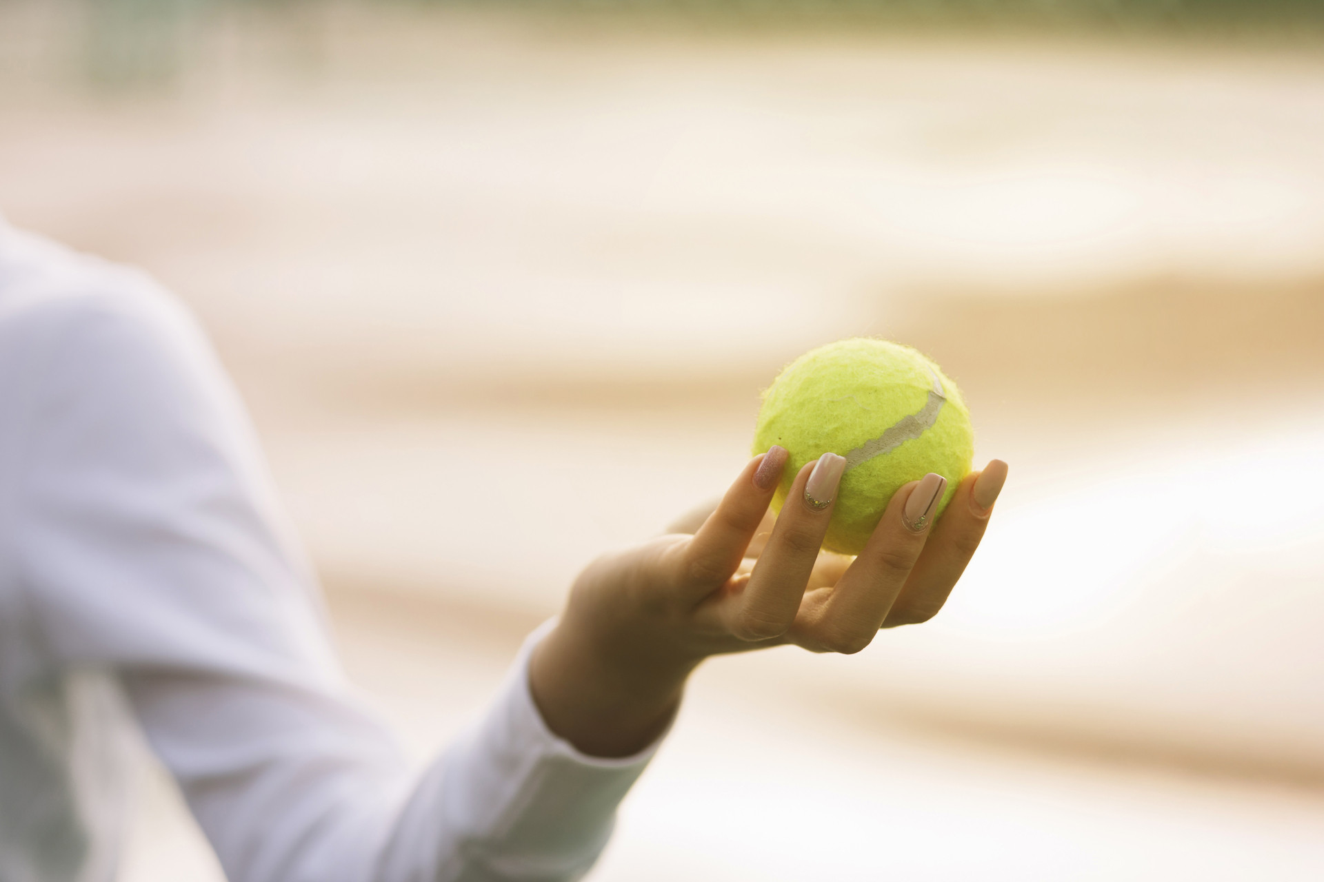 woman holding tennis ball hand (1).jpg