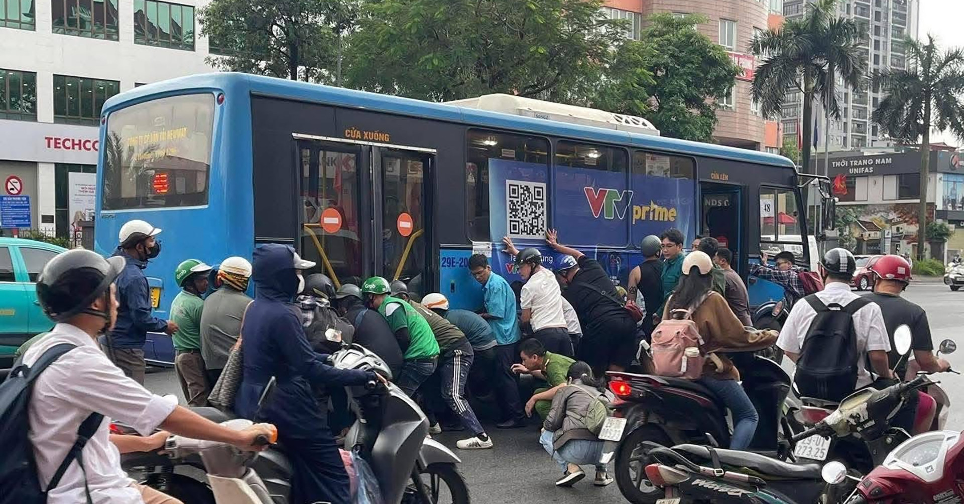 Hà Nội: Nữ tài xế dừng đèn đỏ bị xe buýt tông, hơn 10 người hợp sức nâng xe cứu nạn