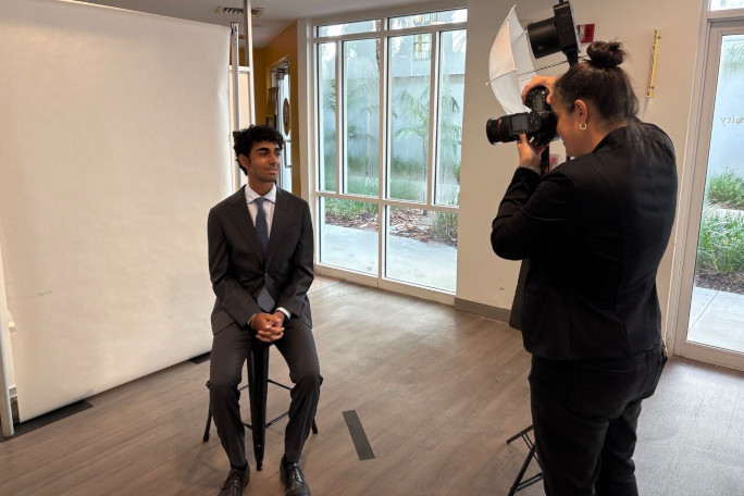 youngest professor nathan getting photo taken.jpg