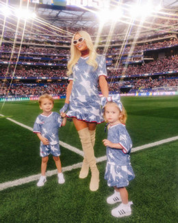 Photo shared by Paris Hilton on June 27, 2026 tagging ashleyosborn, and 11.11media. May be an image of child, American football, football and text (1).jpeg
