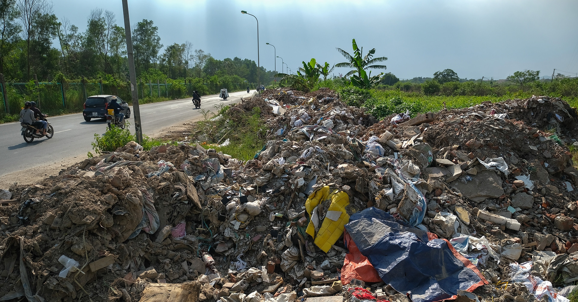 Waste and debris overtake side roads of Thang Long Boulevard