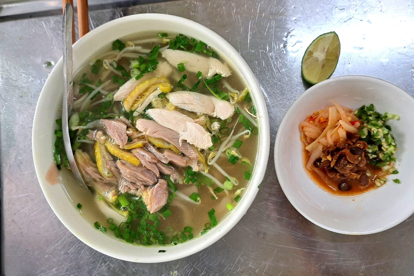 Red noodle soup elaborately processed, served with free-range chicken