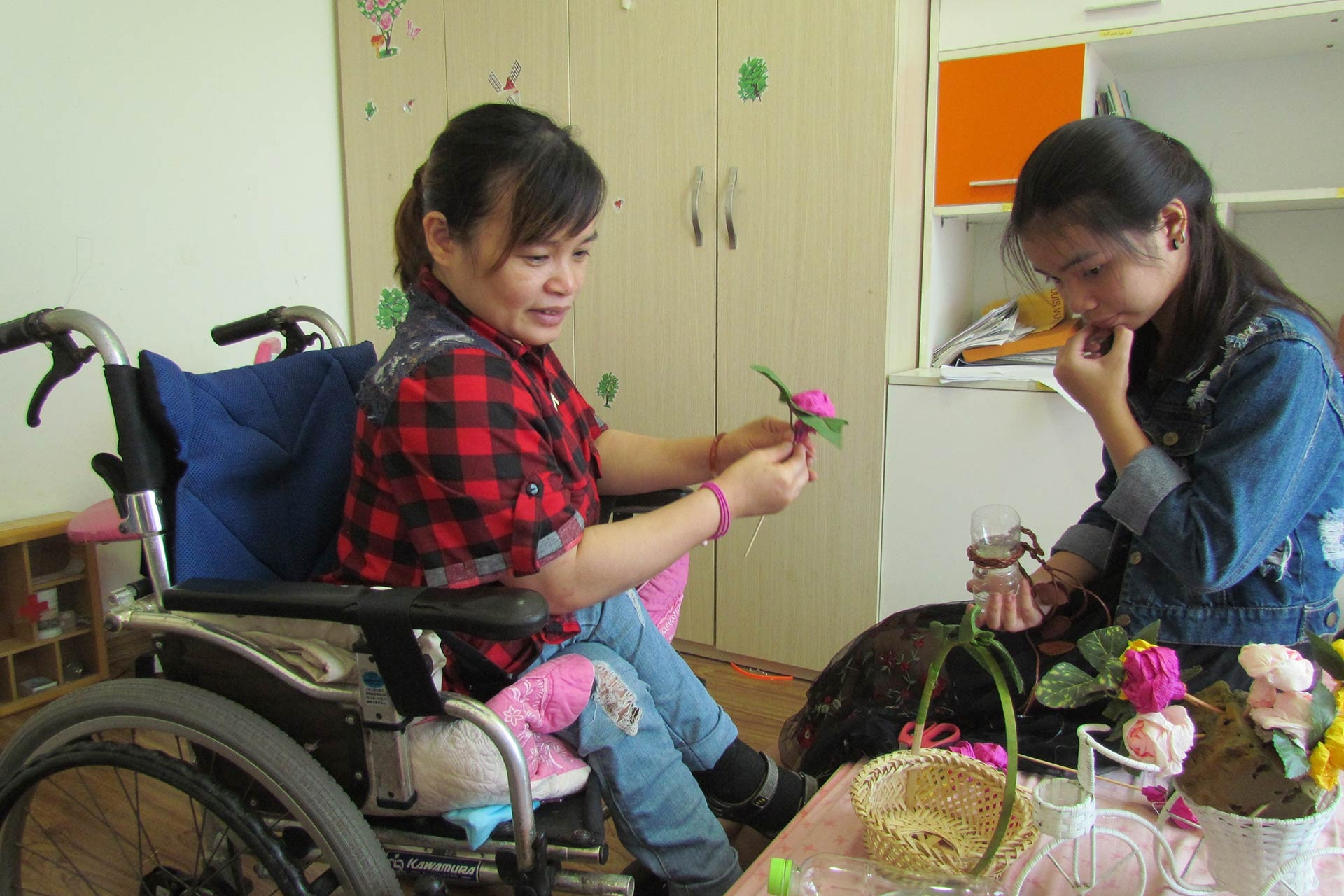 Woman in wheelchair beats fate, turns old items into colourful flower baskets