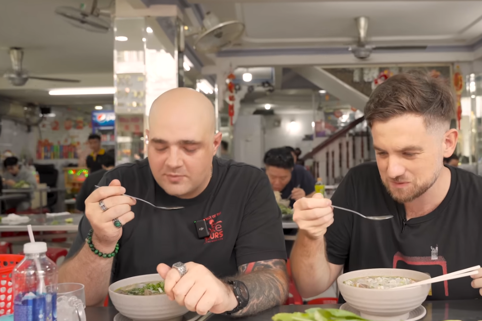 Foreign diners sample pho at 54-year-old shop in HCM City