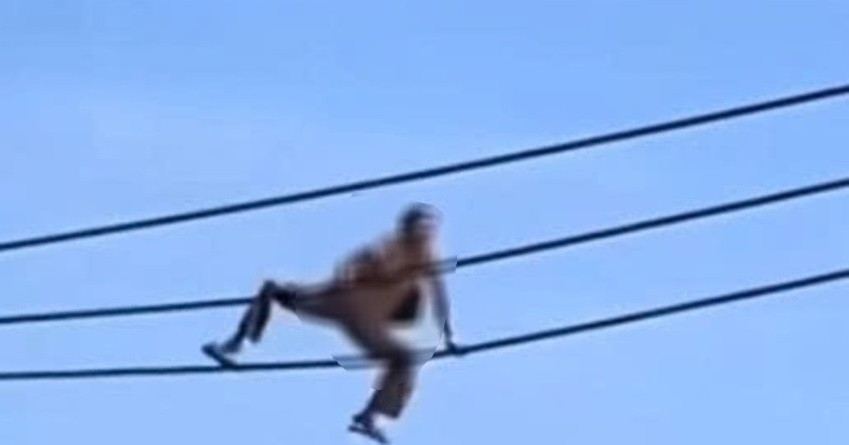 Woman climbs power pole, walks on wire, falls to her death