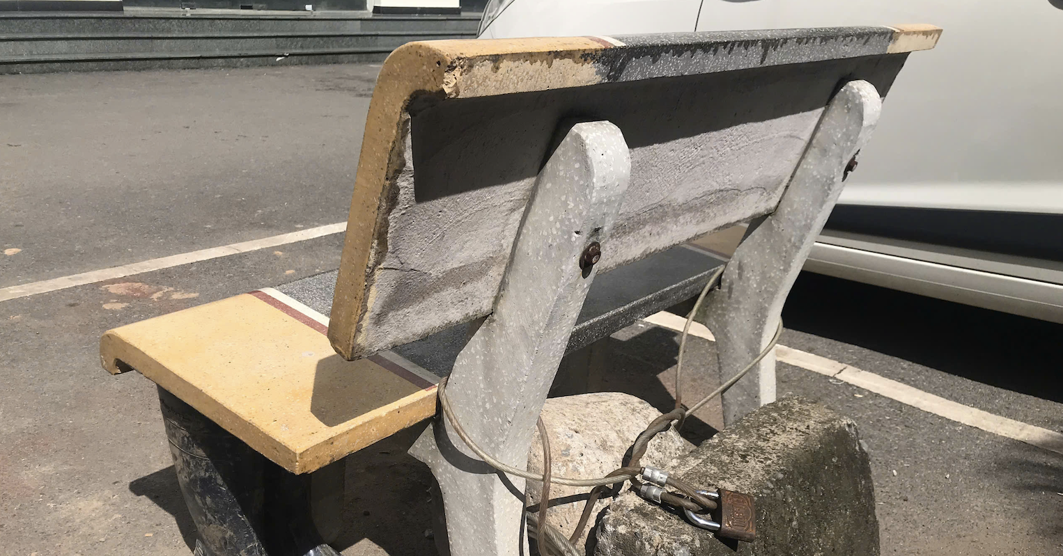 Bench and concrete block ‘reserve’ car space in Hanoi apartment lot