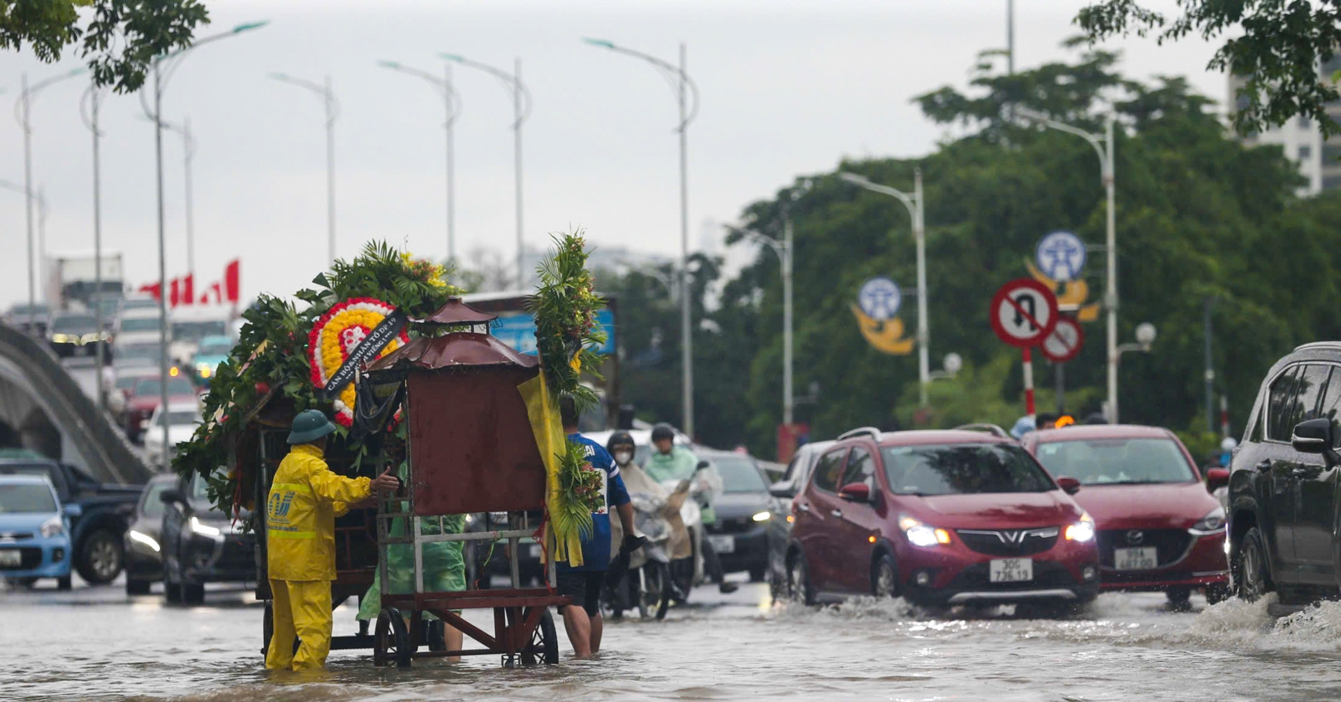 Hanoi streets submerged, funeral car stuck as Storm Kajiki floods capital