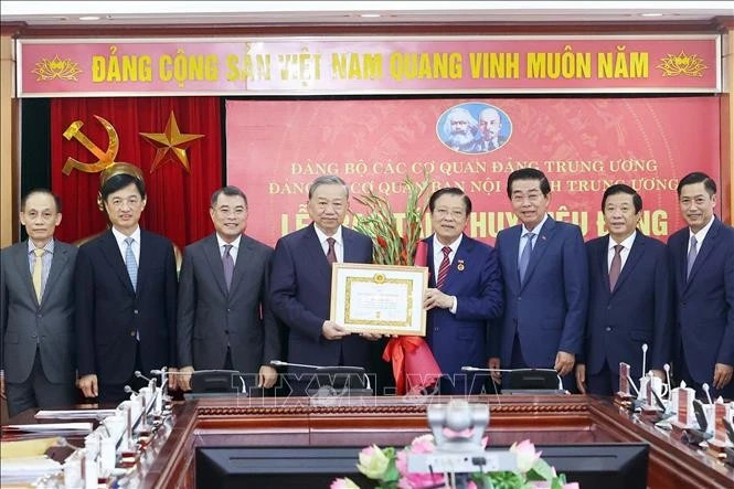Party chief presents 45-year Party membership badge to Politburo member