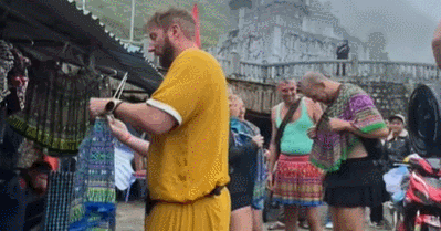 Foreign male tourists wearing Hmong women's dresses sparks cultural backlash