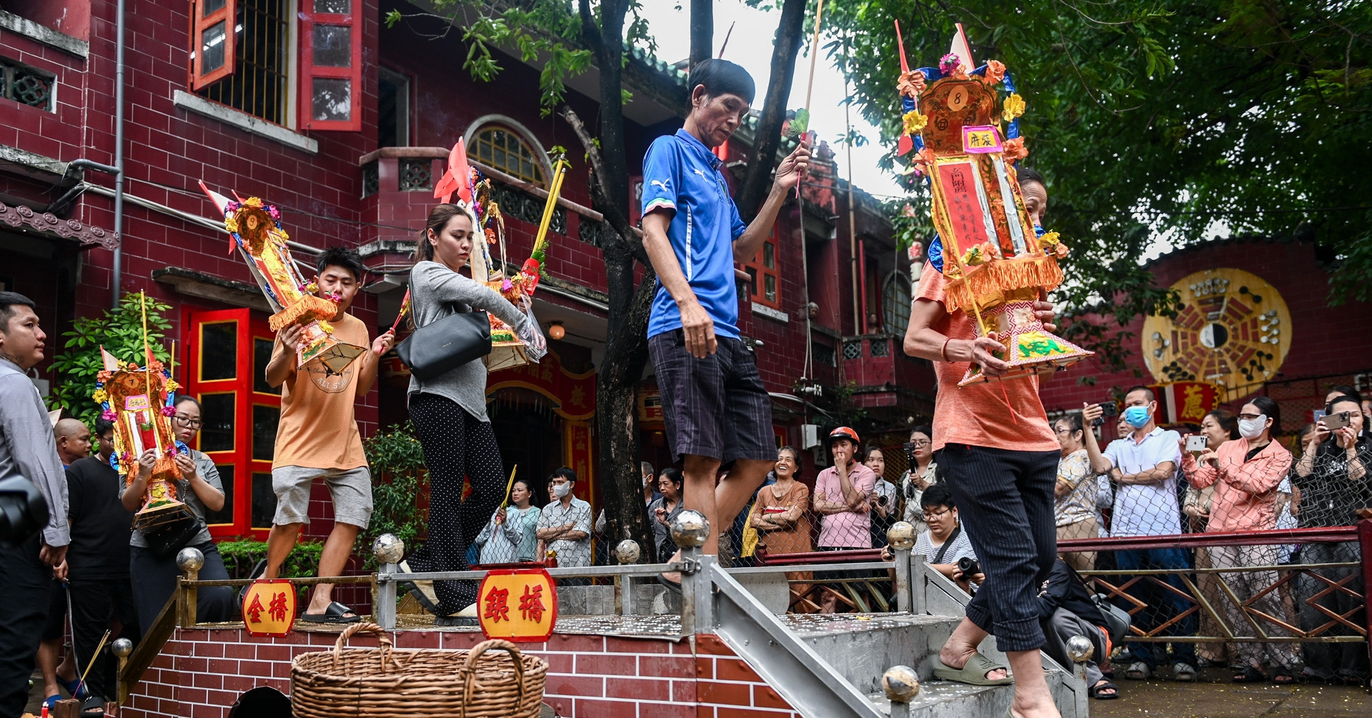Families carry ancestral tablets in Ho Chi Minh City ritual for the dead