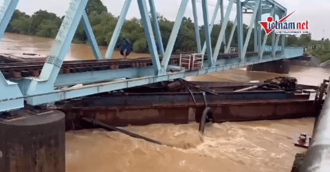 Floodwaters sweep three barges into railway bridge in central Vietnam